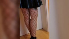 Wearing Latex Skirt Fishnet Stockings And High Heel Boots